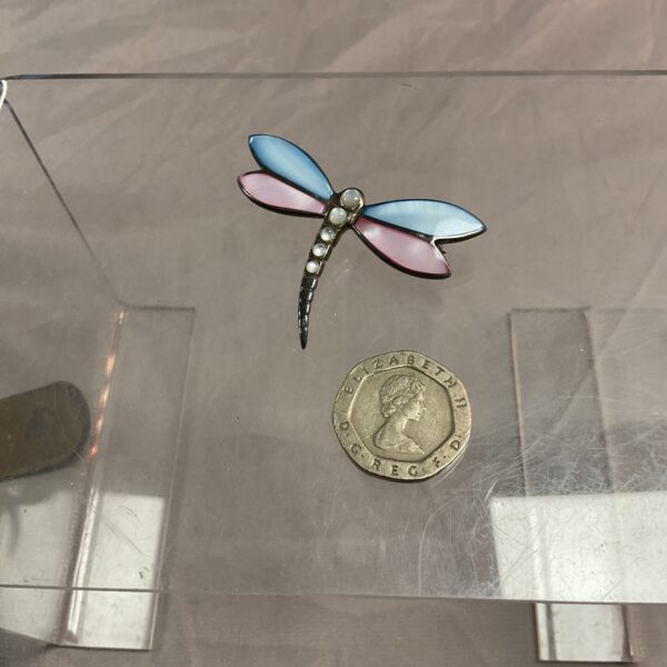Vintage silver enamel dragonfly brooch with blue and pink wings.