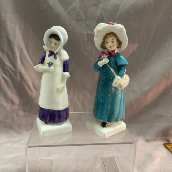Vintage Royal Doulton Carrie and Anna porcelain figures on display.
