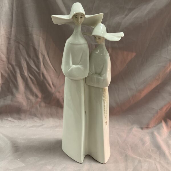 Large Lladro porcelain figure of two nuns, detailed religious sculpture.