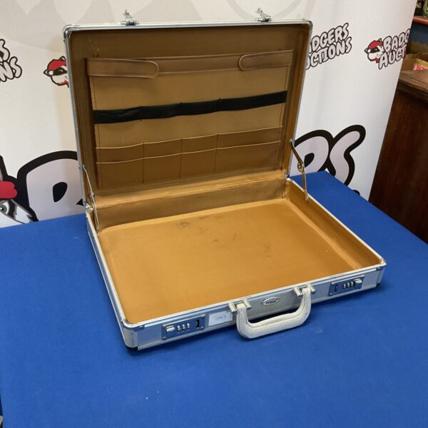 Vintage aluminium storage case with a secure locking mechanism.