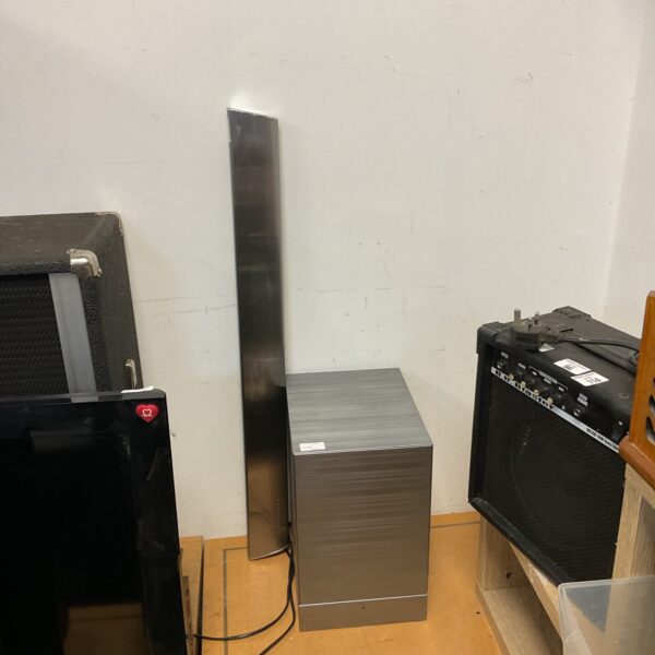 LG NB4540 soundbar system with subwoofer in a room setting.