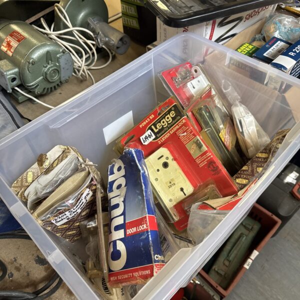 Assorted vintage door furniture in a storage tub.
