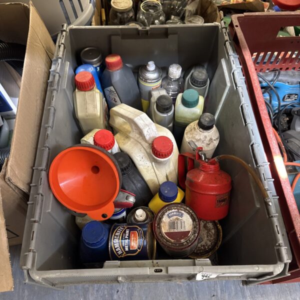 Shed clearance lot with various automotive fluids and cleaning products.