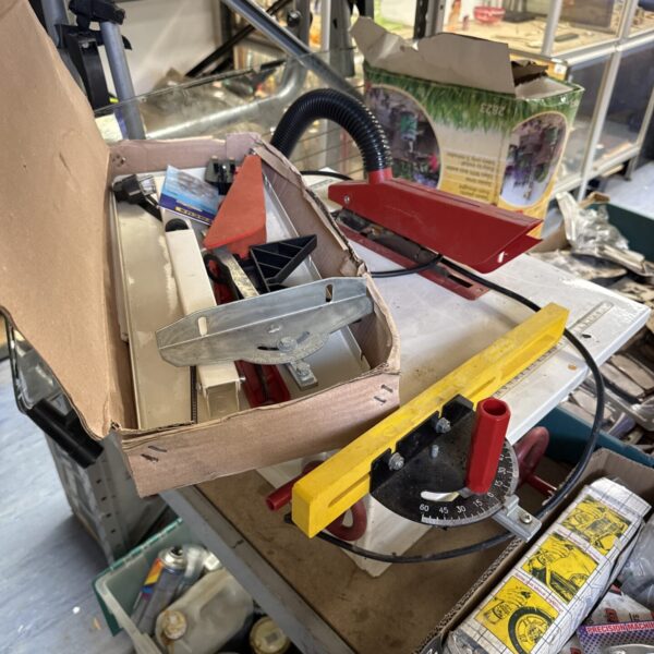 Used Jet table saw with box of accessories for woodworking.