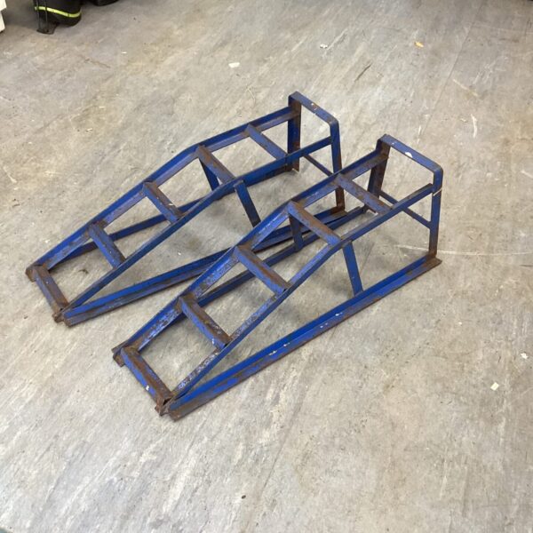 Set of metal axel ramps for vehicle maintenance.