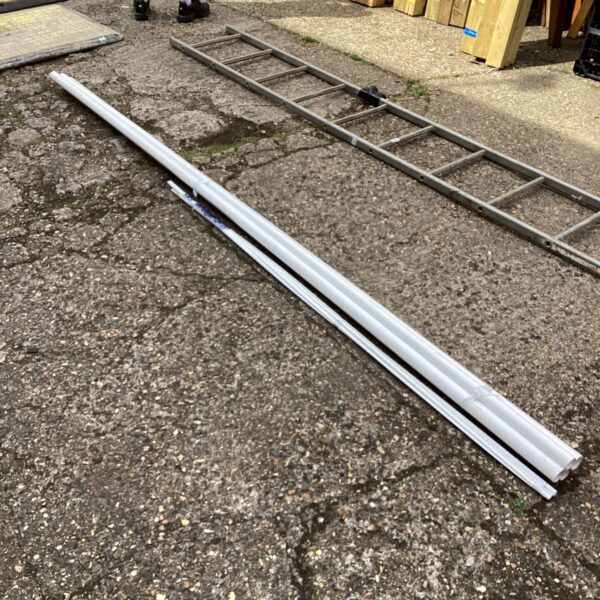 White plastic drainage piping sections for garden drainage projects.