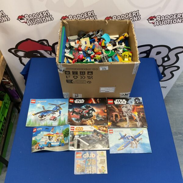 Large mixed Lego lot with bricks and manuals for building.