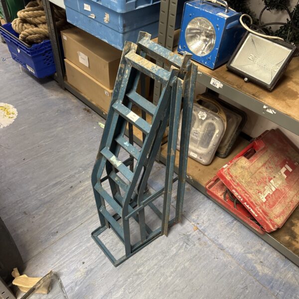 Pair of metal vehicle maintenance ramps for car repair.