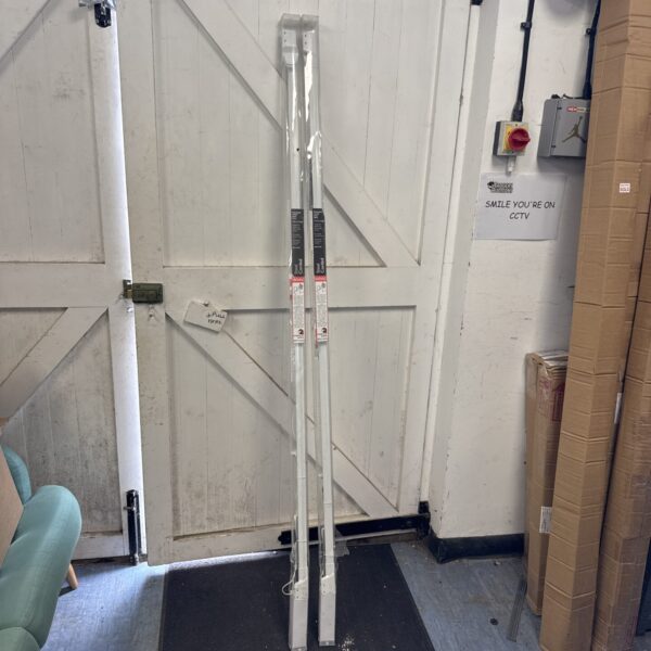 White John Lewis curtain track leaning against a door.