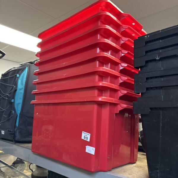 Stack of eight red plastic storage tubs for organisation.
