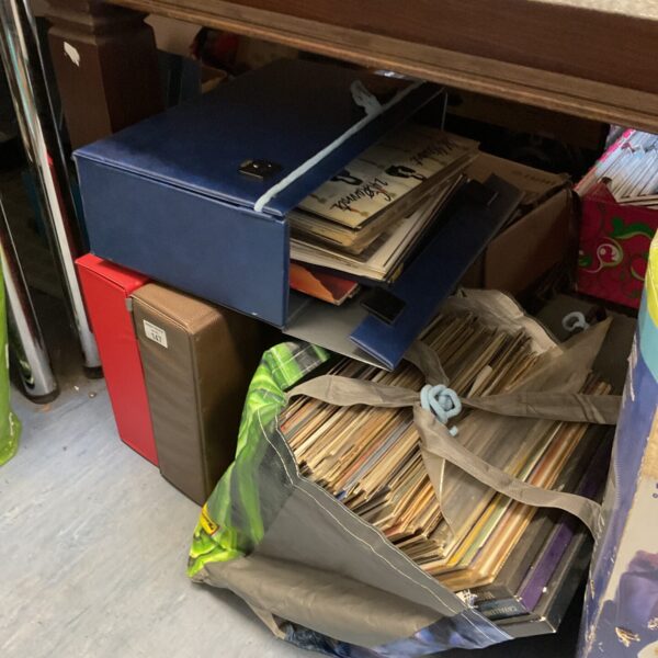 Stack of cardboard cases containing a large vinyl record collection.