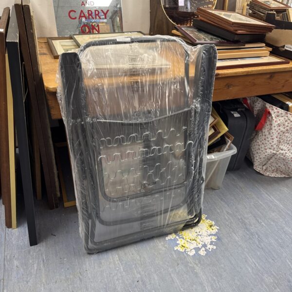 New folding garden chair still sealed in packaging.