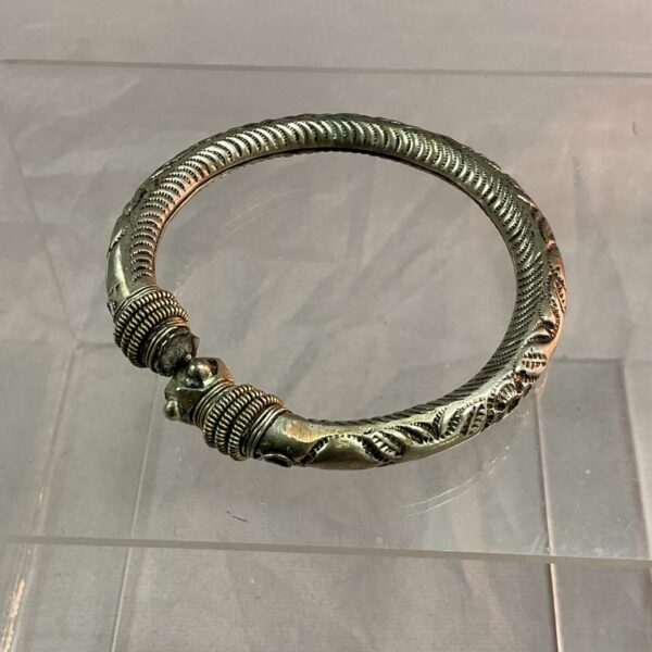 Intricate Indian silver bracelet with animal head details.