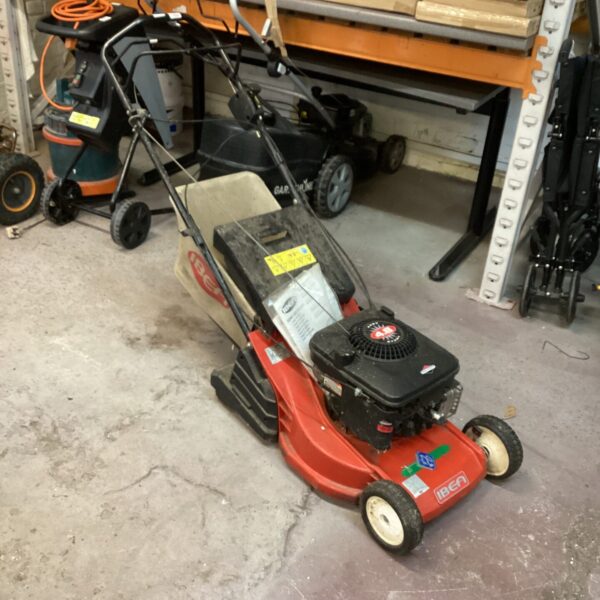 Red IBen petrol lawn mower for garden maintenance.