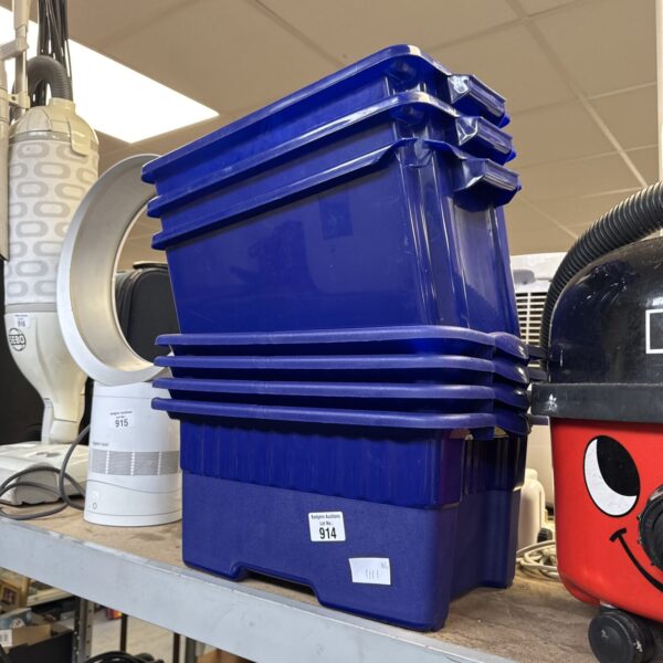 Stack of seven small blue plastic storage containers for organisation.