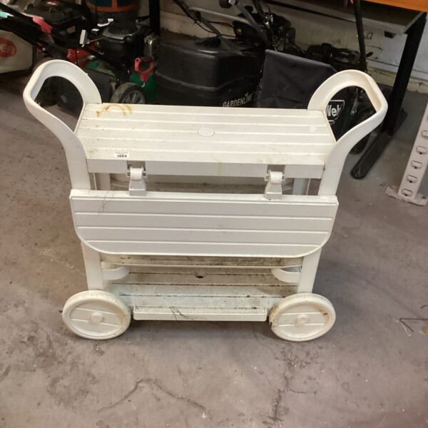 White plastic garden trolley with three wheels for outdoor use.