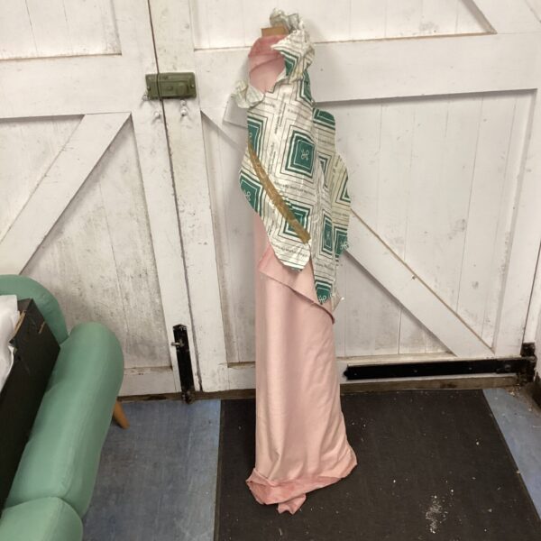 Large roll of pink fabric, ideal for dressmaking projects.