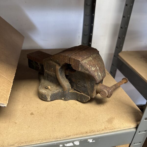 Vintage Woden bench vice, a classic metal workshop tool.