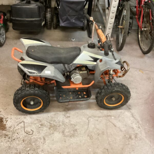 Child's petrol quad bike for off-road fun and recreation.