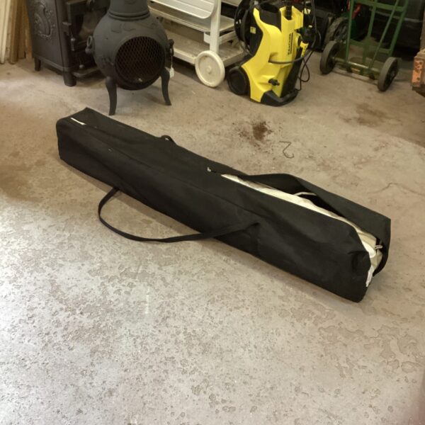 Collapsed telescopic gazebo stored in a black carrying case.