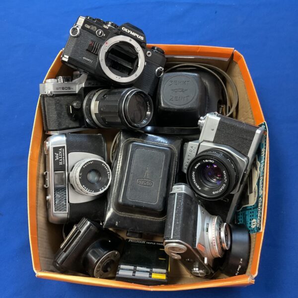 Vintage camera lot featuring Olympus OM10 and Zenit cameras.