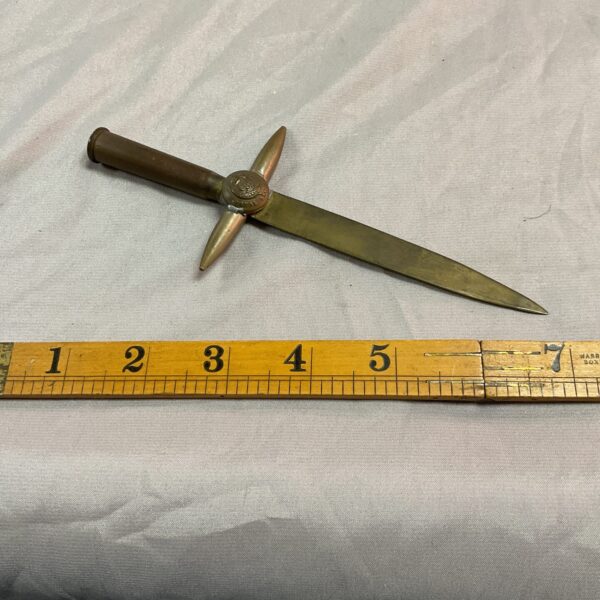 Vintage brass WWI trench art letter opener with military crest.