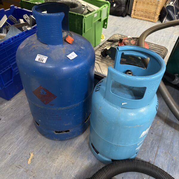 Pair of blue patio gas bottles for outdoor heating.