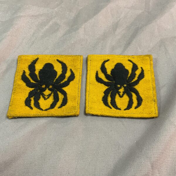 Pair of vintage military spider cloth badges for collectors.