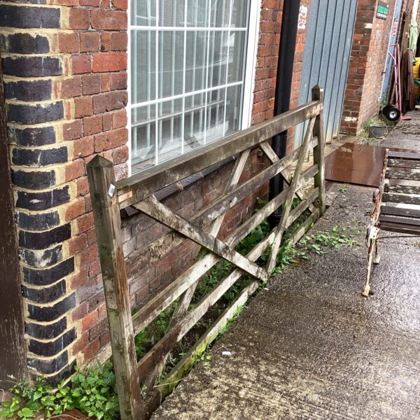 Rustic wooden 5 bar gate in a rural setting.