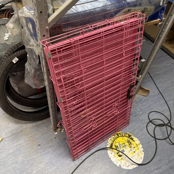 Pink medium pet crate for dogs and cats.