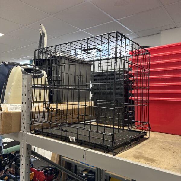 Black wire pet cage for small animals, side view.