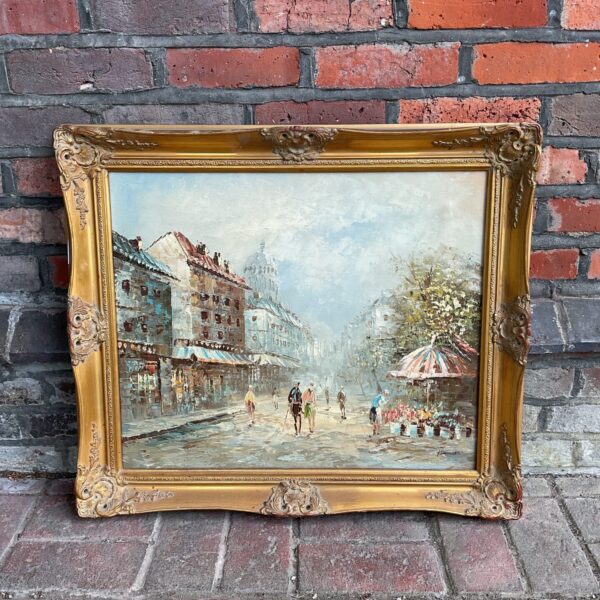 Brunette signed gilt framed oil painting of a french street scene
