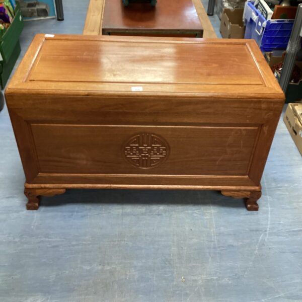 Front view of antique Oriental rosewood chest with carved details.