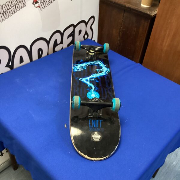 Enuff skateboard displayed on a blue backdrop.