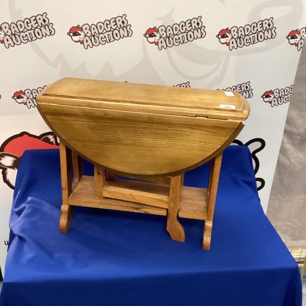 Antique oak gate leg table with folded legs.