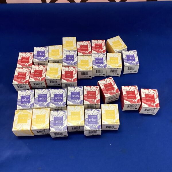 Lot of Clarins Armo scented candles in original packaging.