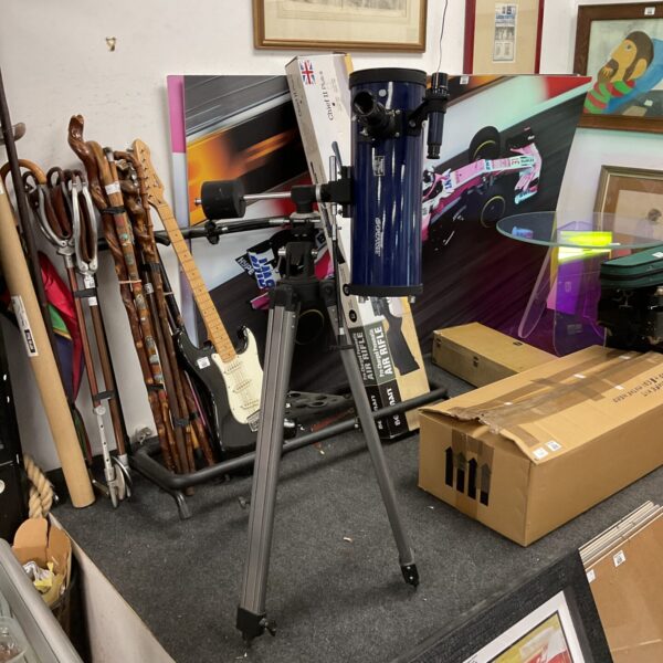 Vintage Tasco telescope on tripod, ideal for astronomy enthusiasts and collectors.