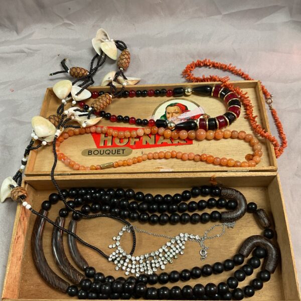 Vintage stone and coral necklace lot in a cigar box.
