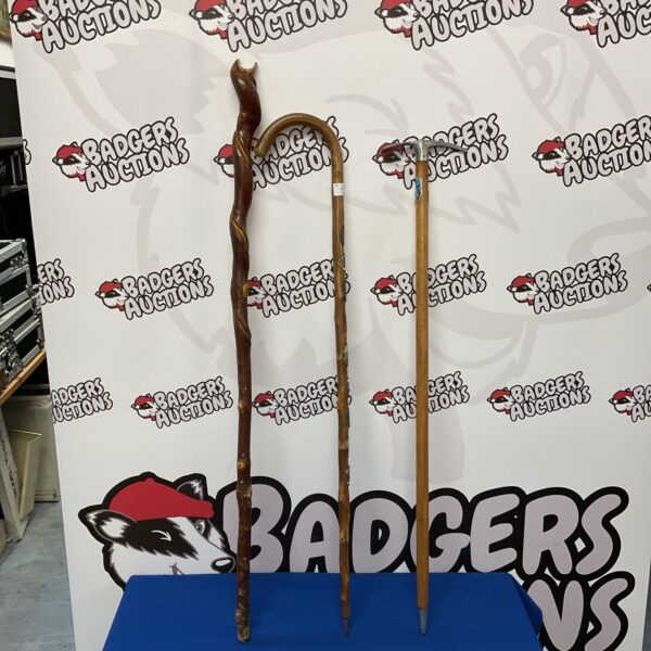 Lot of three vintage walking sticks, including a pickaxe handled cane.