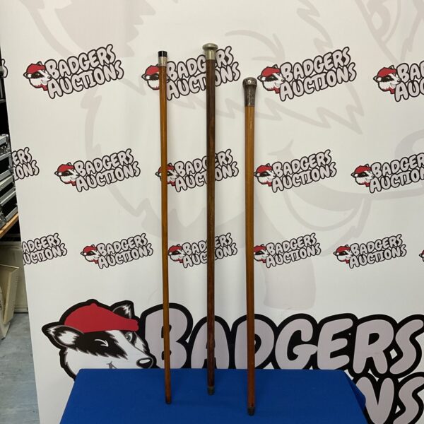 Three vintage walking sticks with silver knops