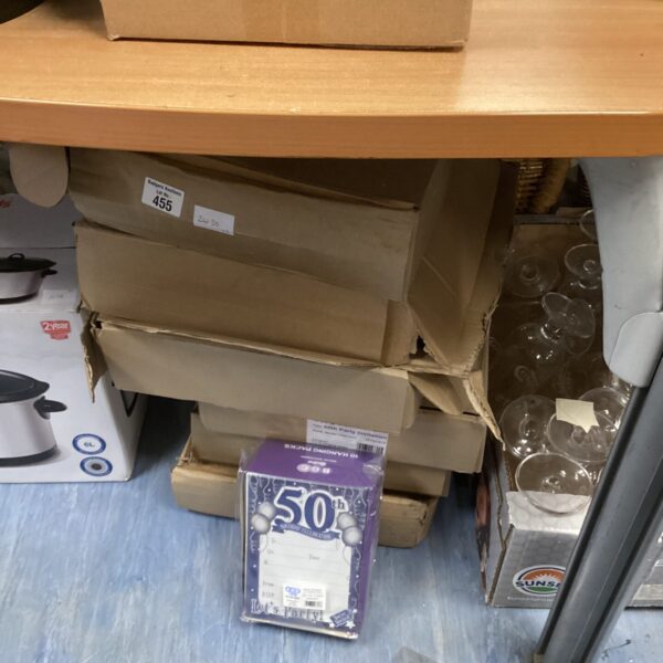 Stack of six boxes containing assorted birthday invitations for parties.