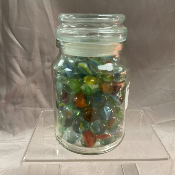 Clear jar filled with colourful vintage glass marbles.