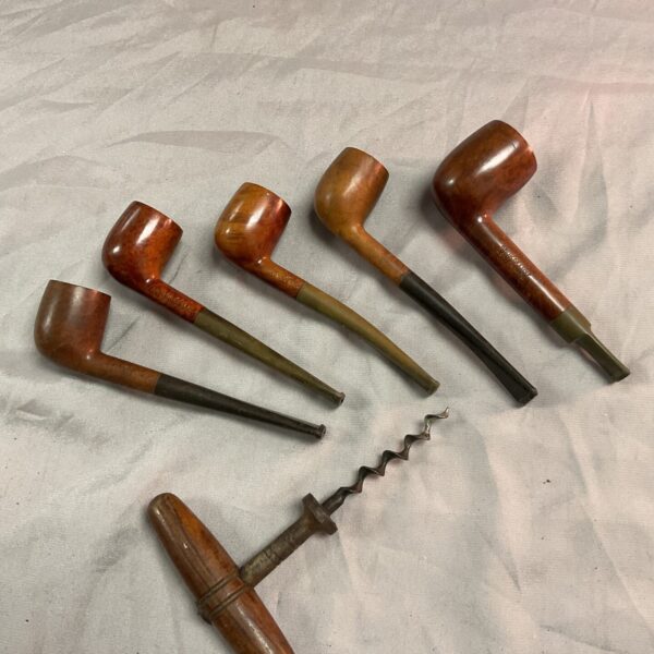 Vintage briar pipes and antique corkscrew collection.