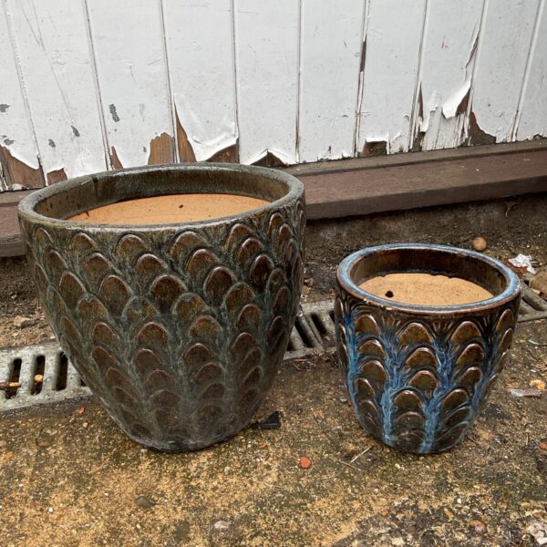 Vintage glazed ceramic plant pots with a scale-like pattern.