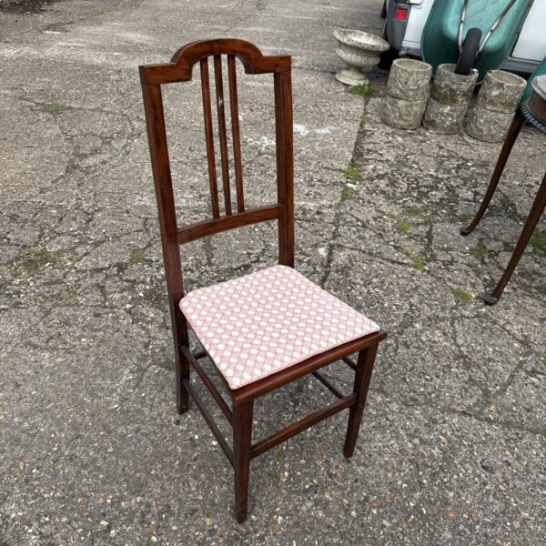 Vintage mahogany hall chair with woven seat and spindle back.