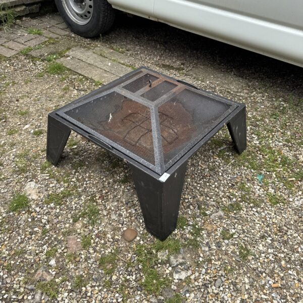 Metal garden fire pit with mesh design for outdoor heating.
