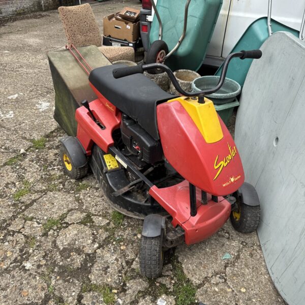 Red Wolf Garten ride on lawnmower in a garden setting.