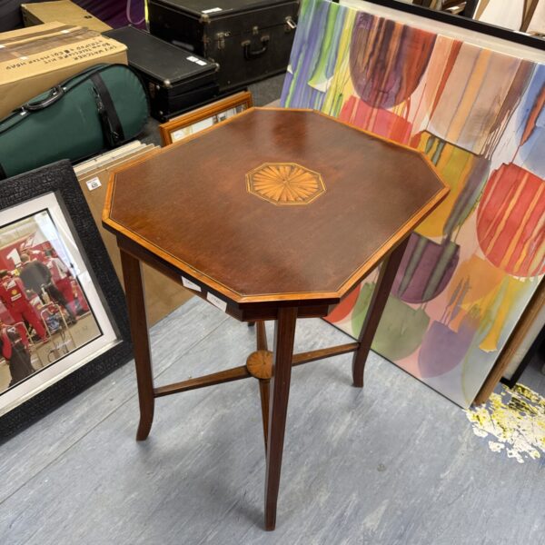 Edwardian occasional table with inlaid mahogany top and slender legs.