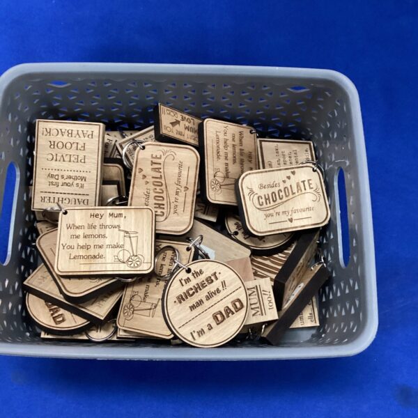 Lot of colourful novelty wooden keyrings for collectors.
