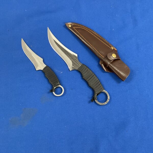 Pair of fixed blade sheath knives with brown leather sheath.